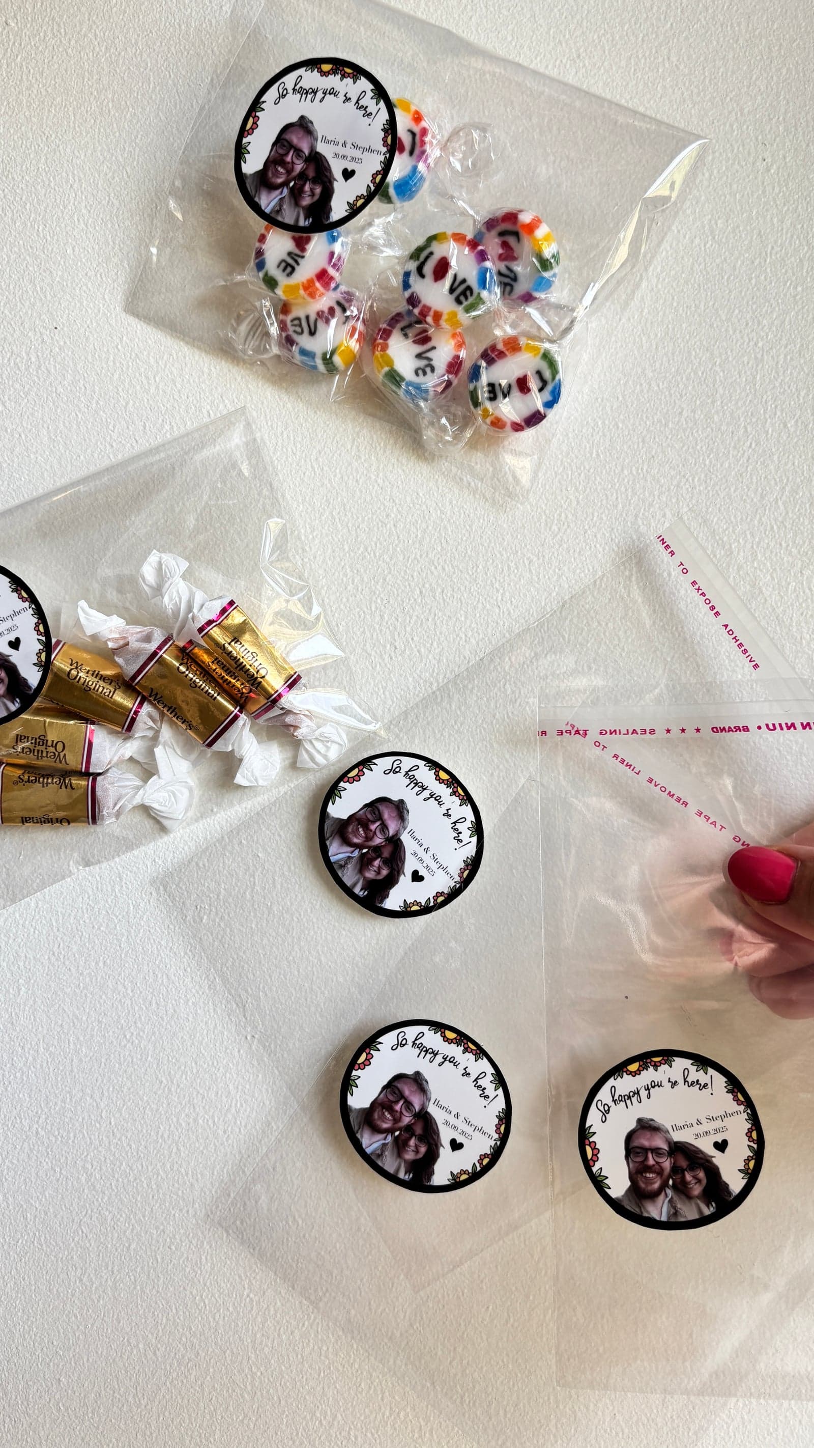 Clear favour bags filled with sweets, sealed with round photo stickers
