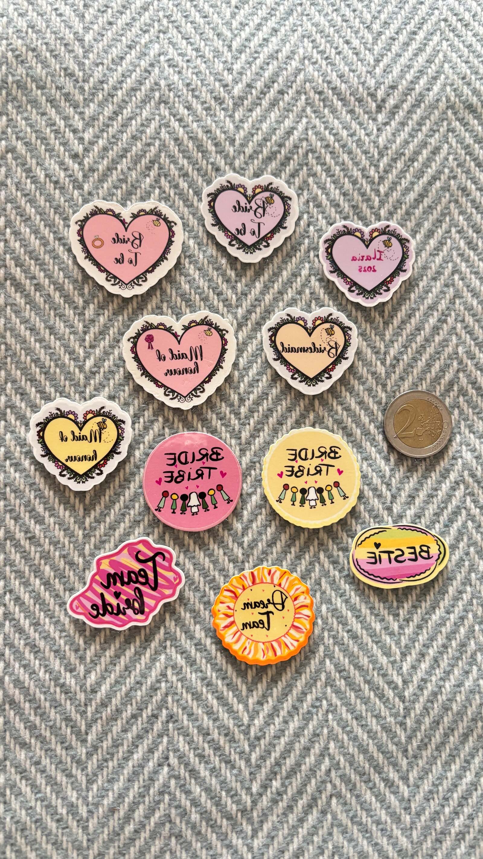 Temporary hen party tattoos in pink, yellow and orange, including Bride to Be, Bride Tribe and Team Bride designs